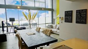 City Fringe Apartment with Sky Tower and City Views في أوكلاند: غرفة معيشة مع طاولة وأريكة