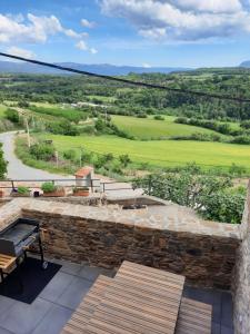 a view from the balcony of a house with a stone wall at Corral de l'esquirol in Basturs