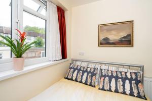 a bedroom with a window and a plant on the sill at F5 Private Double Room (Sandycroft Guest House) in London