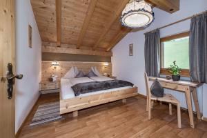 a bedroom with a bed and a wooden ceiling at Treffhof in Siusi