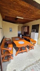 a wooden table and chairs in a room at Pensiunea Vlad in Arad