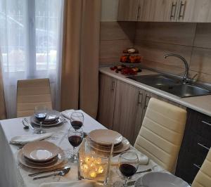 a table with glasses of wine and a candle on it at Chrissi Princess in Skala Sotiros