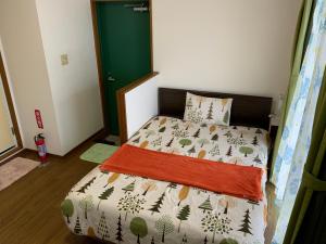 Postel nebo postele na pokoji v ubytování Asahi21 Asahibashi-Ekimae