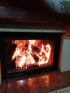 a fire in a fireplace with flames in it at B&b L'Oasi del Vulture in Rapolla