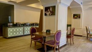 a dining room with a table and chairs at Rusel Park Hotel in Baku