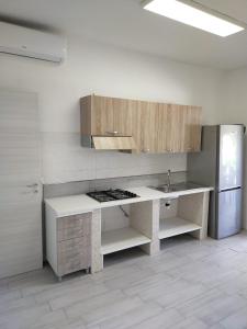 a kitchen with a counter and a sink and a refrigerator at Oriental Park in Rossano
