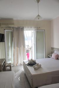 Postel nebo postele na pokoji v ubytování Iason Apartments