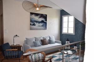 a living room with a white couch and a window at Les Rougemonts Coton in Champguyon