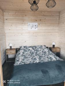 Winnica的住宿－Pod Dębem，卧室配有木墙内的一张床