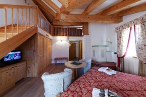 a bedroom with a bed and a wooden ceiling at Campiglio Bellavista in Madonna di Campiglio +75 photos