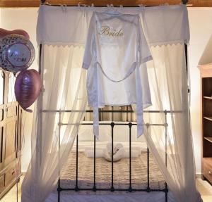 a crib with a tshirt on top of it at Cosmema House 1 Hot tub and swimming pool villa in Stroumbi