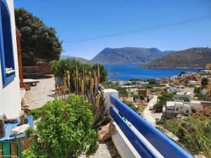 a balcony with a view of a town and the water at Villa Orea Thea, Emborios, Kalymnos in Emborios