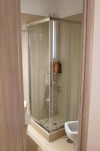 a glass shower in a bathroom with a toilet at Langi Apartments in Missolonghi +72 photos