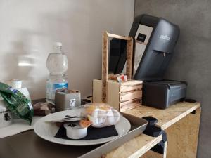 a table with a plate of food and a water bottle at LE MURA Foresteria in Grassobbio