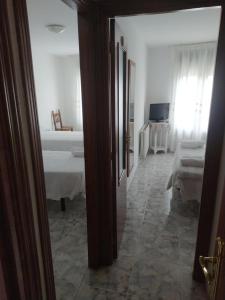 A bed or beds in a room at Hostal Arribes del Duero