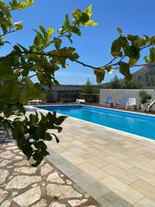 a swimming pool in front of a building at B&B Pelagos in Castellammare del Golfo