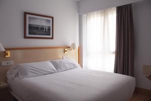 Postel nebo postele na pokoji v ubytování Hotel Ezeiza