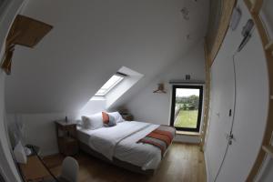 a bedroom with a white bed and a window at Akrenbos 101 in Bever