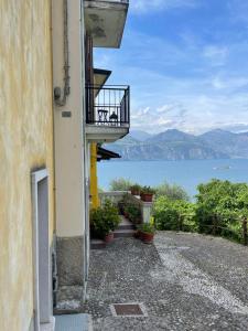 a balcony of a building with a view of the water at Le Due Terrazze in Brenzone sul Garda