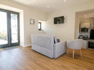 a living room with a couch and a chair at The Hayloft in Bodmin