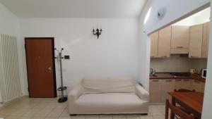a room with a white couch in a kitchen at AL VISTA CIELO in Forlì