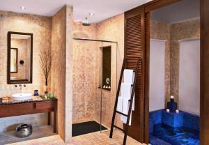 a bathroom with a tub and a sink and a shower at Golden Palm Tree Sepang in Sepang