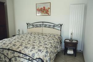 a bedroom with a bed with a floral bedspread at Al Ponte in Cademario