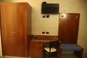 a room with a desk and a cabinet and a chair at B&B Federica's House In Rome in Rome