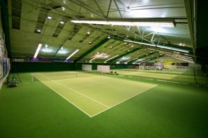 a tennis court in a building with a tennis court at Hotel Centrum in Bydgoszcz