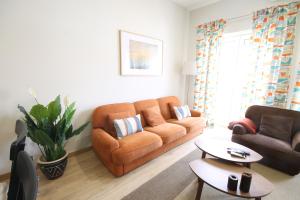 a living room with a couch and a table at Quinta das Conchas Apartment by Trip2Portugal in Lisbon