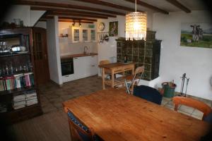 a kitchen with a wooden table and a dining room at Eifel Duitsland fraai vakantiehuis met tuin in Eisenschmitt