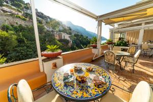 a balcony with a table and chairs at Casa Teresa in Positano