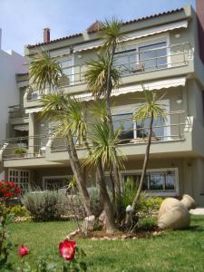 a house with palm trees in front of it at La casa a mare in Artemida