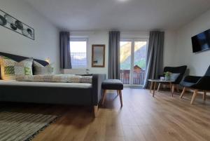 a living room with a couch and a table at Pension Bergfried in Hallstatt