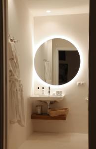 a bathroom with a sink and a mirror at La Ermita Suites - Único Hotel Monumento de Córdoba in Córdoba