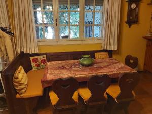 a dining room table with a green vase on it at B&b rustic chic Casa Salva in Molinella