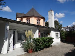 a white house with a tower on top of it at Apartment in Innenstadtnähe in Darmstadt