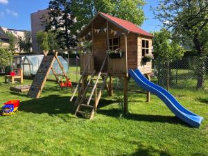 a playground with a slide and a play house at Przystań w Pucku in Puck