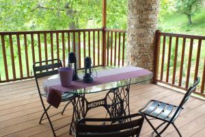 a table on a deck with chairs on a porch at Il Picco in Dronero