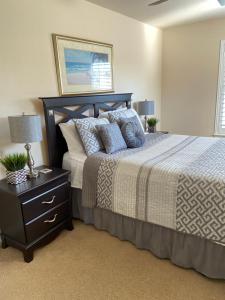 a bedroom with a bed and a night stand with a lamp at Cozy Villa With South Facing Pool in Davenport