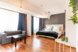 a bedroom with a bed and a couch at Schäfers Hotel in Cloppenburg