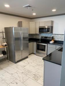 a kitchen with a stainless steel refrigerator and appliances at Irish American INN in Newport +36 photos