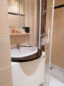 a bathroom with a white sink and a shower at Rance solidor ter in Saint Malo +92 photos