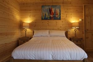 a bedroom with a bed with two lamps on two tables at Paull Holme Farm Bed and Breakfast in Paull