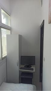 a bedroom with a bed and a computer on a desk at Cozy Rooms and Small Partitions for Men guests in Dubai in Dubai