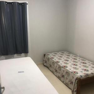 a small bedroom with a bed and a window at Ed. Oliveiro Lucena in João Pessoa