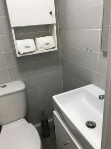 a bathroom with a white toilet and a sink at myCasa in Espinho