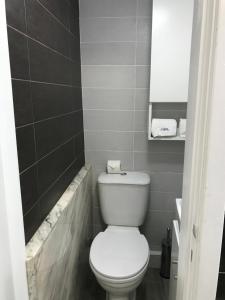 a bathroom with a white toilet and a mirror at myCasa in Espinho