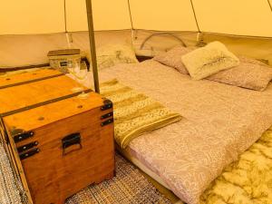 a bedroom with a bed and a glass of wine at Murimäe Winery glamping in Otepää