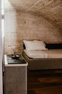 a bedroom with a bed and a table with a night stand at Pietraluna luxury b&b in Giovinazzo +56 photos